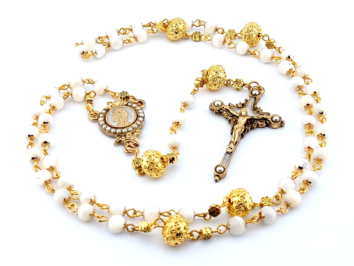 Mother of pearl Our Lady of Grace rosary beads with pearl and gold crucifix and gold Our Father beads.