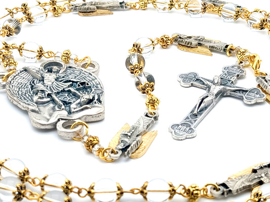Saint Michael unique rosary beads with clear glass beads, golden bead caps, silver crucifix, centre medal and angel pater beads.