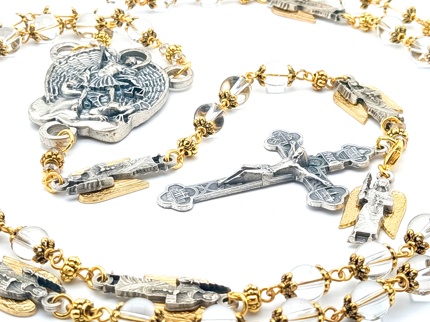 Saint Michael unique rosary beads with clear glass beads, golden bead caps, silver crucifix, centre medal and angel pater beads.