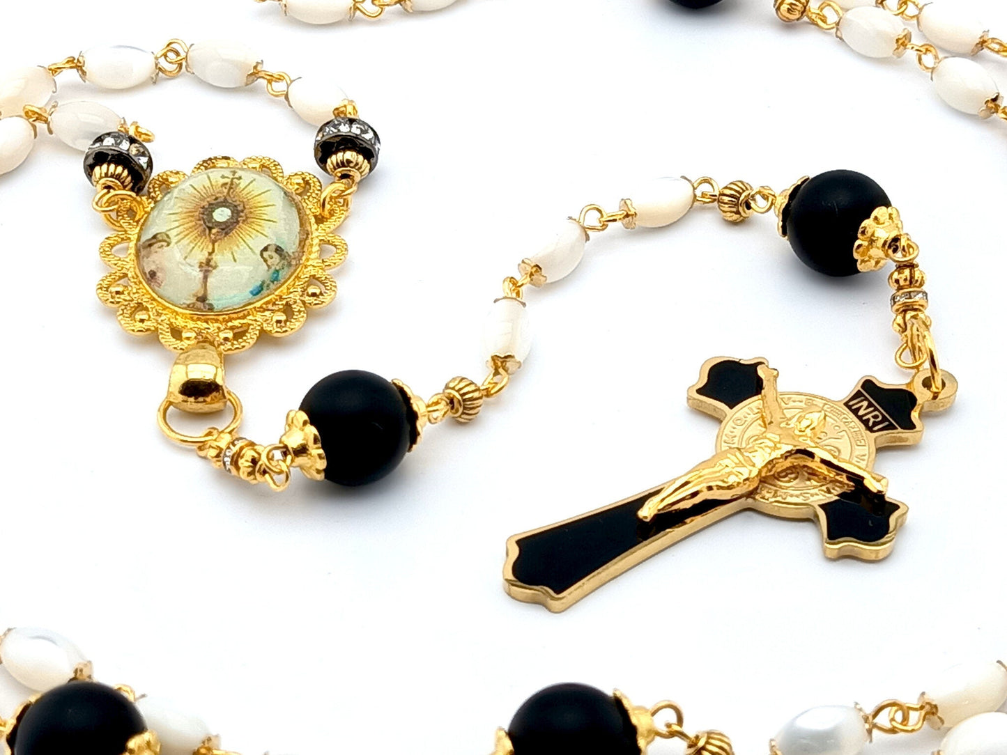 Holy Eucharist unique rosary beads with mother of pearl and matt black onyx beads, black and gold enamel crucifix and golden picture centre medal.