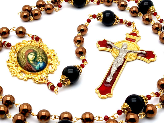 Our Lady of Perpetual Help unique rosary beads with hematite and onyx gemstone beads and red and gold enamel Saint Benedict crucifix.