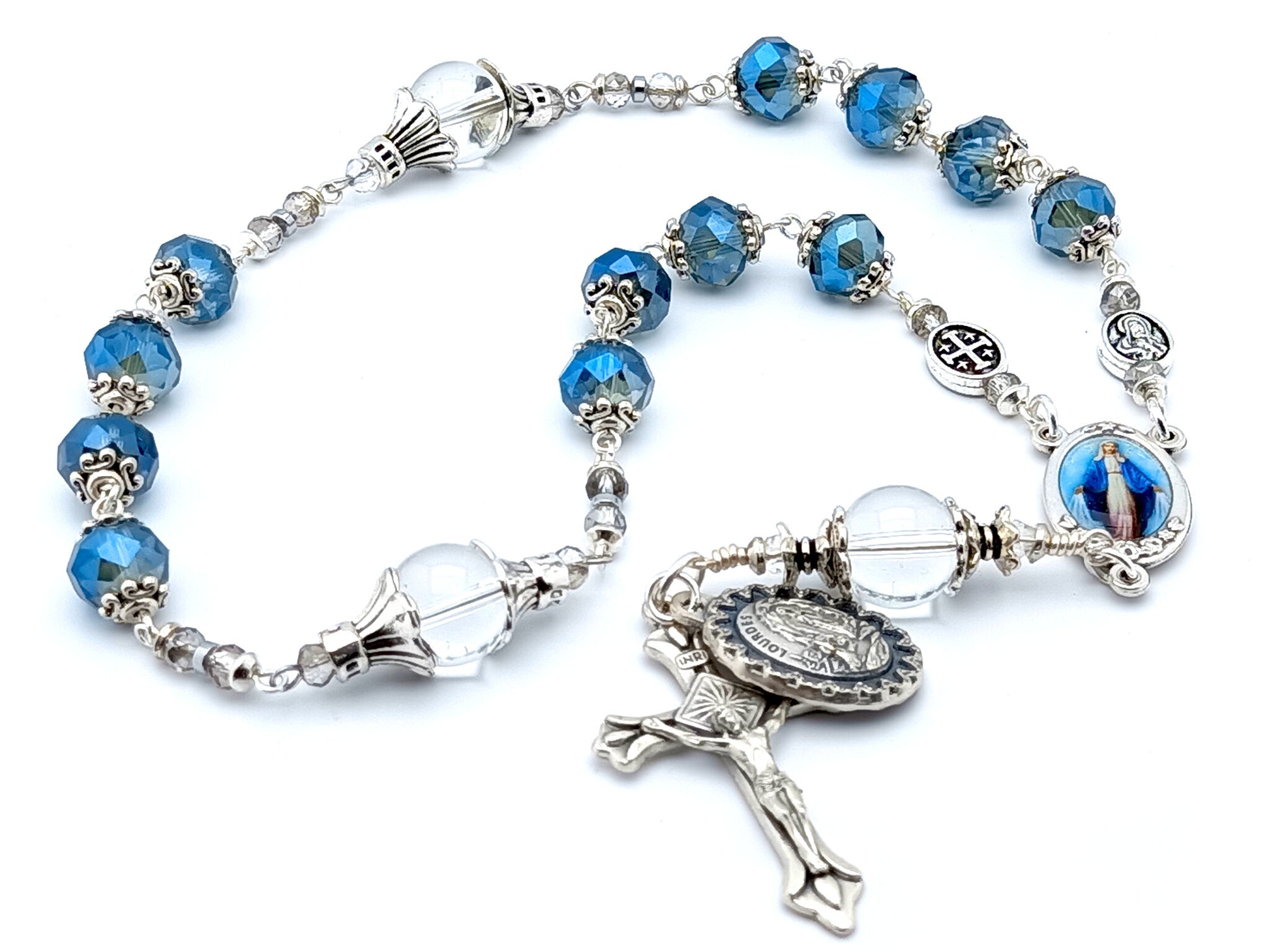 The Immaculate Conception unique rosary beads prayer chaplet with blue crystal faceted and clear crystal beads, picture centre medal and silver sunburst crucifix and Our Lady of Lourdes medal.