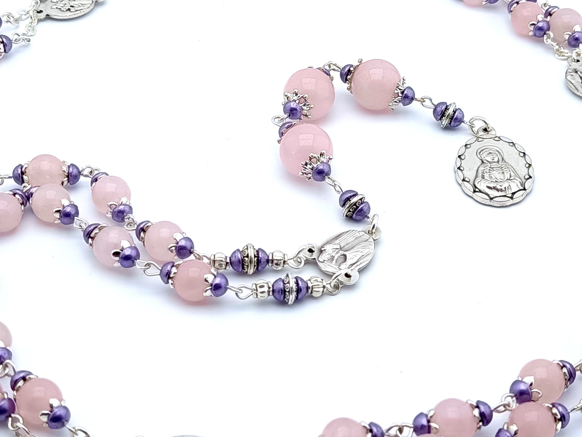 Our Lady of Sorrows unique dolor rosary beads with pale pink glass beads, silver dolour medals and purple bead caps. 