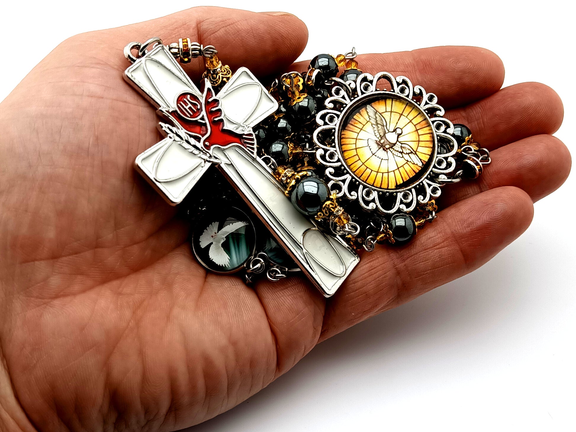 Holy Spirit unique rosary beads prayer chaplet with hematite gemstone beads and Holy Ghost enamel cross and domed linking picture medals.