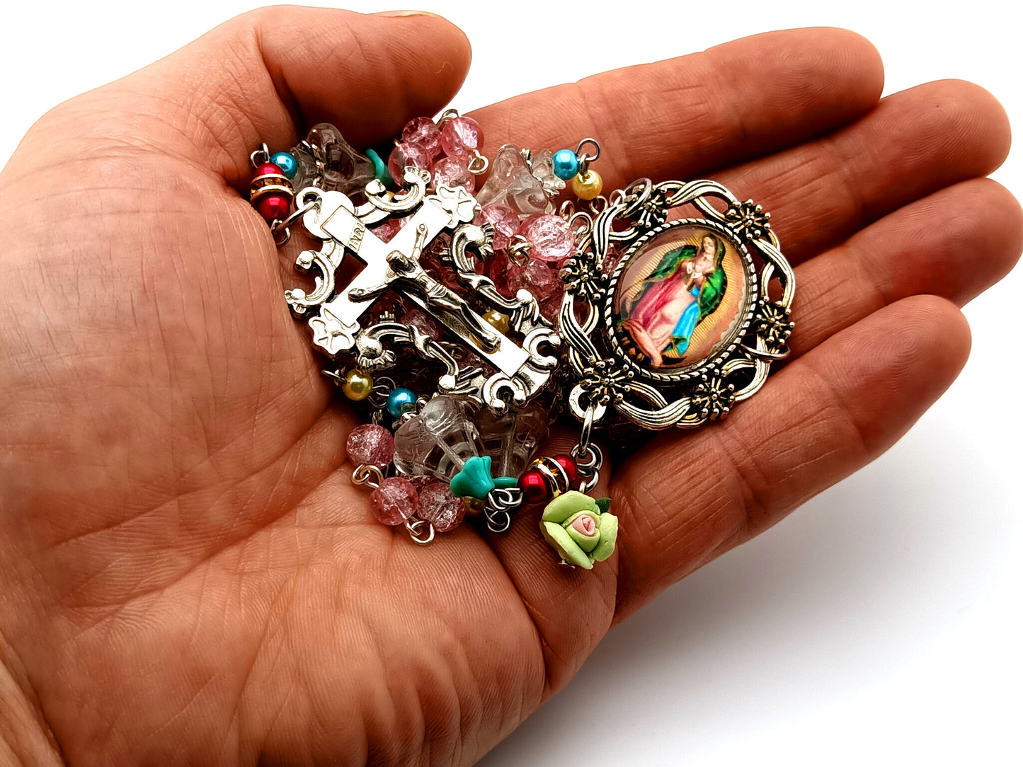 Our Lady of Guadalupe unique rosary beads with crackled glass and flower petal rosary beads and filigree crucifix and floral silver medal frame.