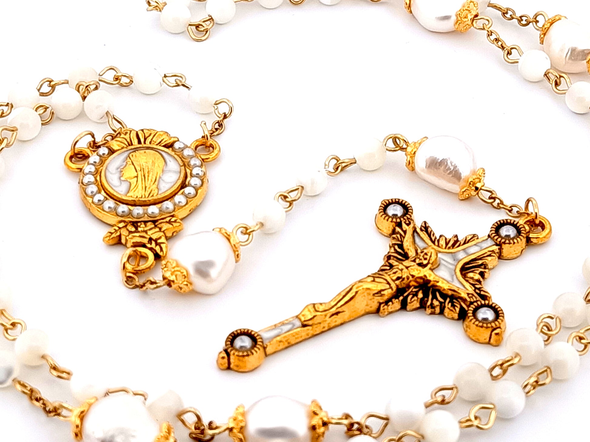 Virgin Mary unique rosary beads mother of pearl and fresh water pearl rosary with gold plated pearl sunburst crucifix.