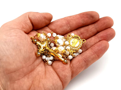 Virgin Mary unique rosary beads mother of pearl and fresh water pearl rosary with gold plated pearl sunburst crucifix.