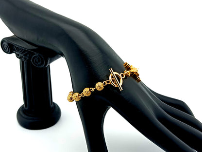 18K Gold cubic zirconia single decade rosary bracelet with gold plated Saint Benedict crucifix.