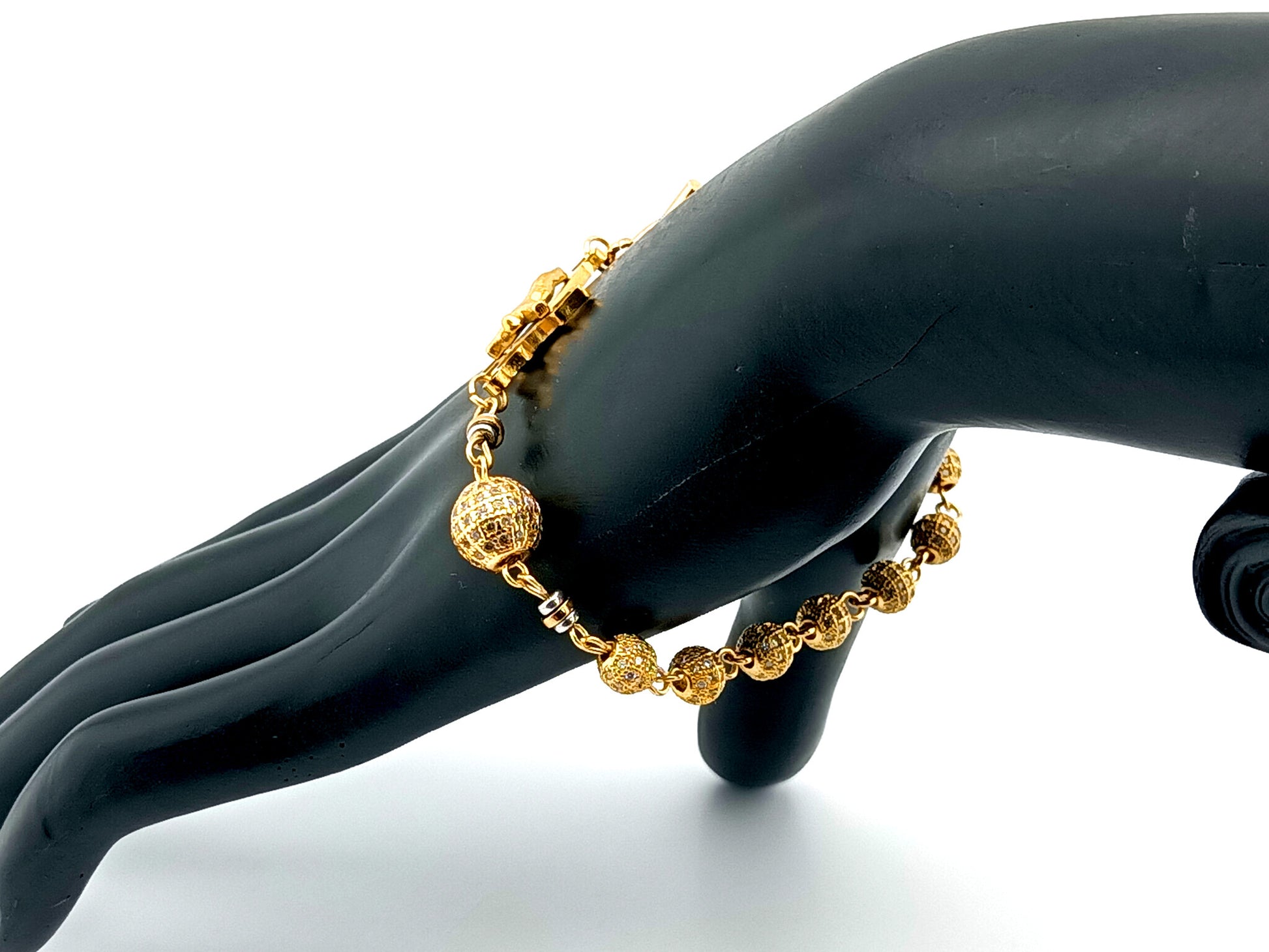 18K Gold cubic zirconia single decade rosary bracelet with gold plated Saint Benedict crucifix.