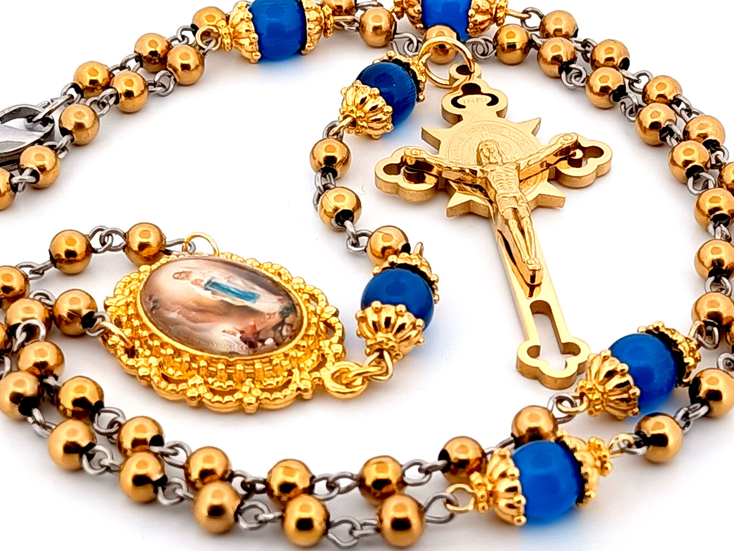 Our Lady of Lourdes unique rosary beads gold plated stainless steel and blue cats eye glass rosary with gold plated Saint Benedict crucifix.