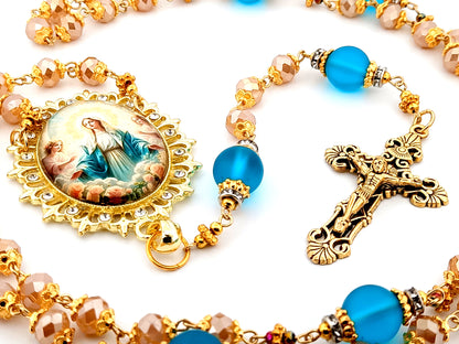 Assumption of Our Lady unique rosary beads rose gold faceted and blue glass beads with gold plated filigree crucifix.