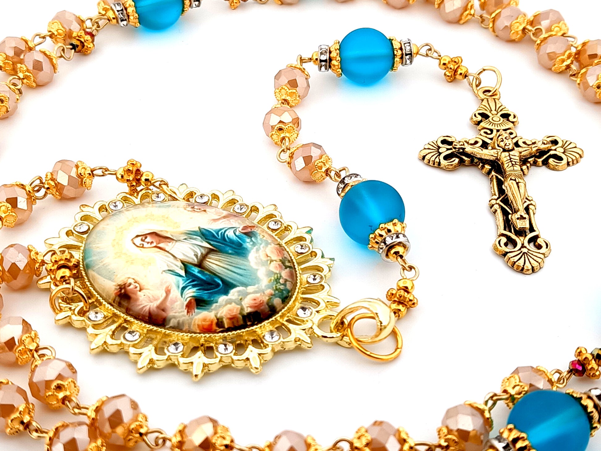 Assumption of Our Lady unique rosary beads rose gold faceted and blue glass beads with gold plated filigree crucifix.