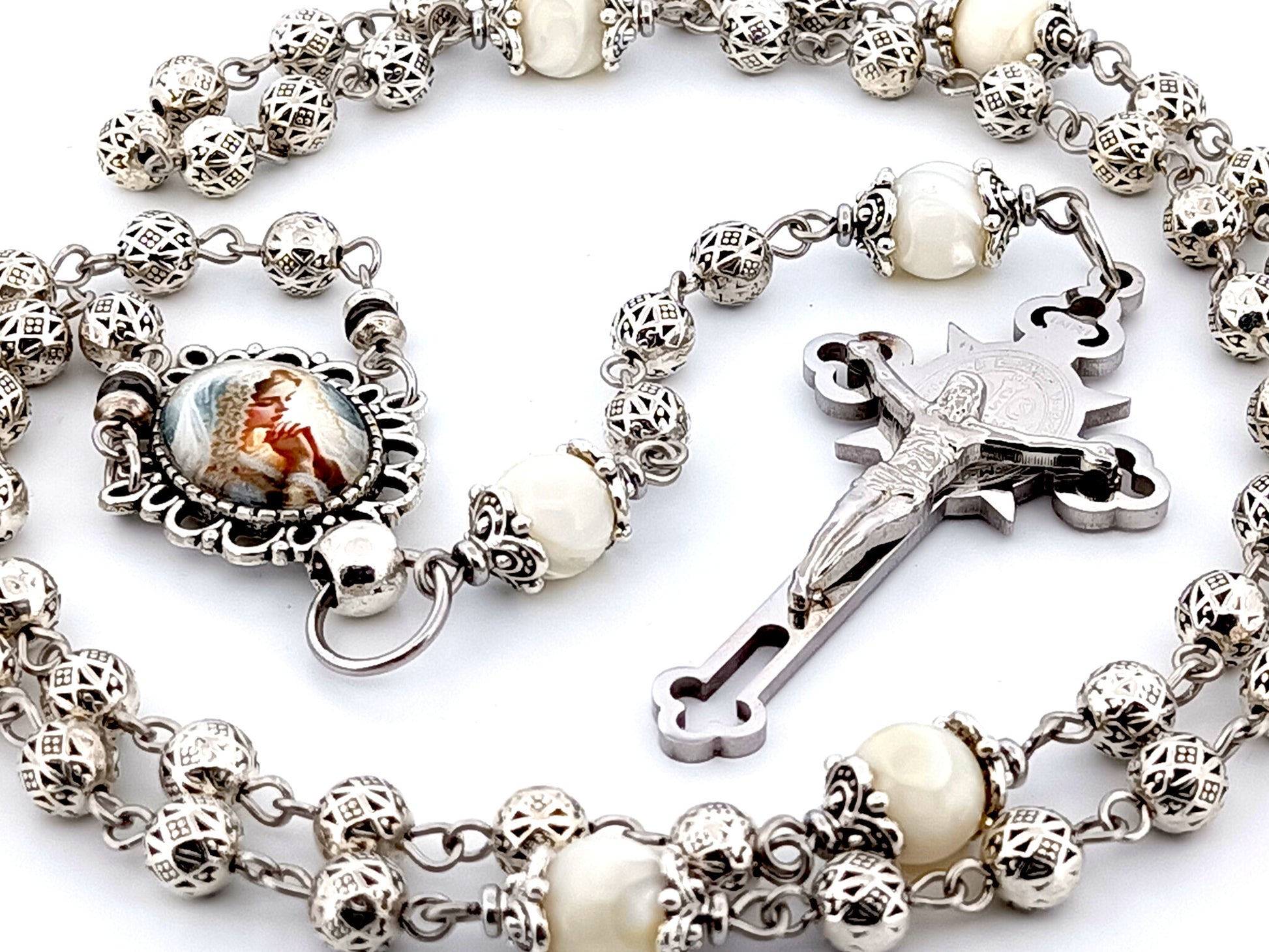 Our Lady Praying silver and mother of pearl unique rosary beads with stainless steel Saint Benedict crucifix.