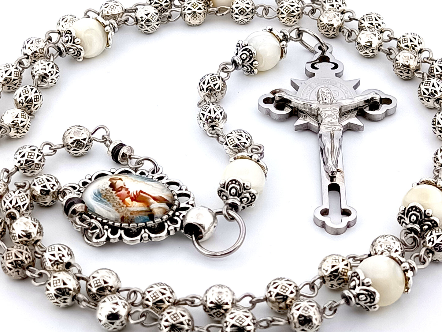 Our Lady Praying silver and mother of pearl unique rosary beads with stainless steel Saint Benedict crucifix.