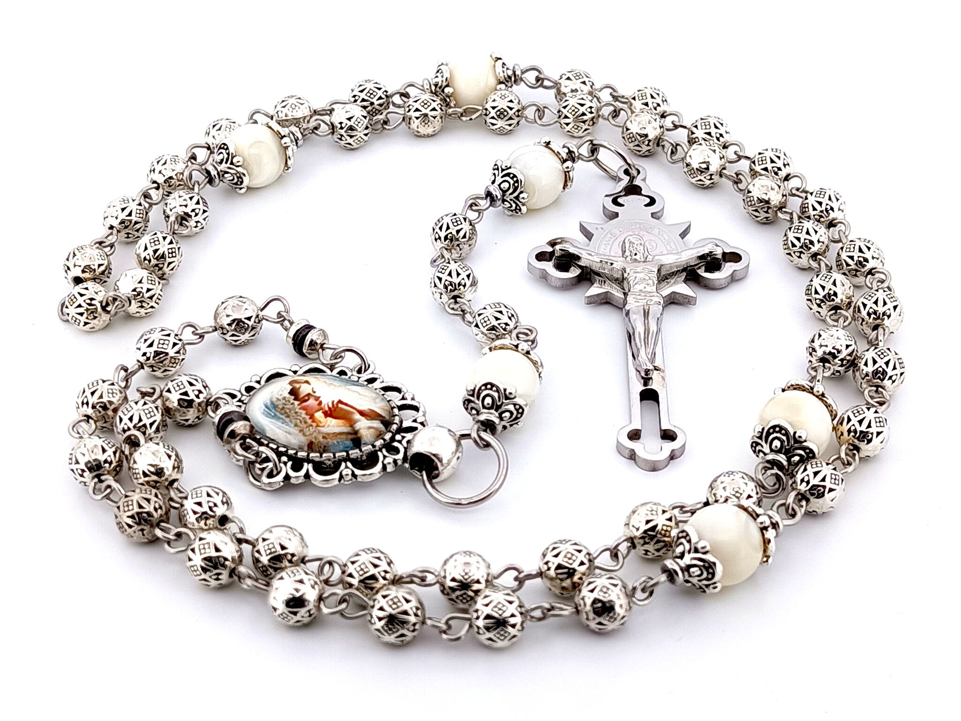 Our Lady Praying silver and mother of pearl unique rosary beads with stainless steel Saint Benedict crucifix.