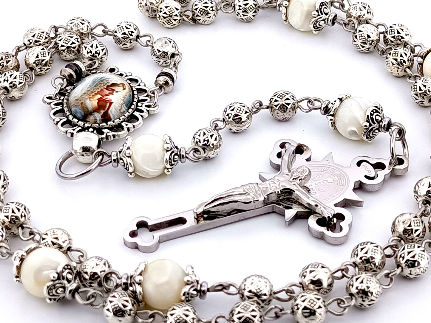 Our Lady Praying silver and mother of pearl unique rosary beads with stainless steel Saint Benedict crucifix.