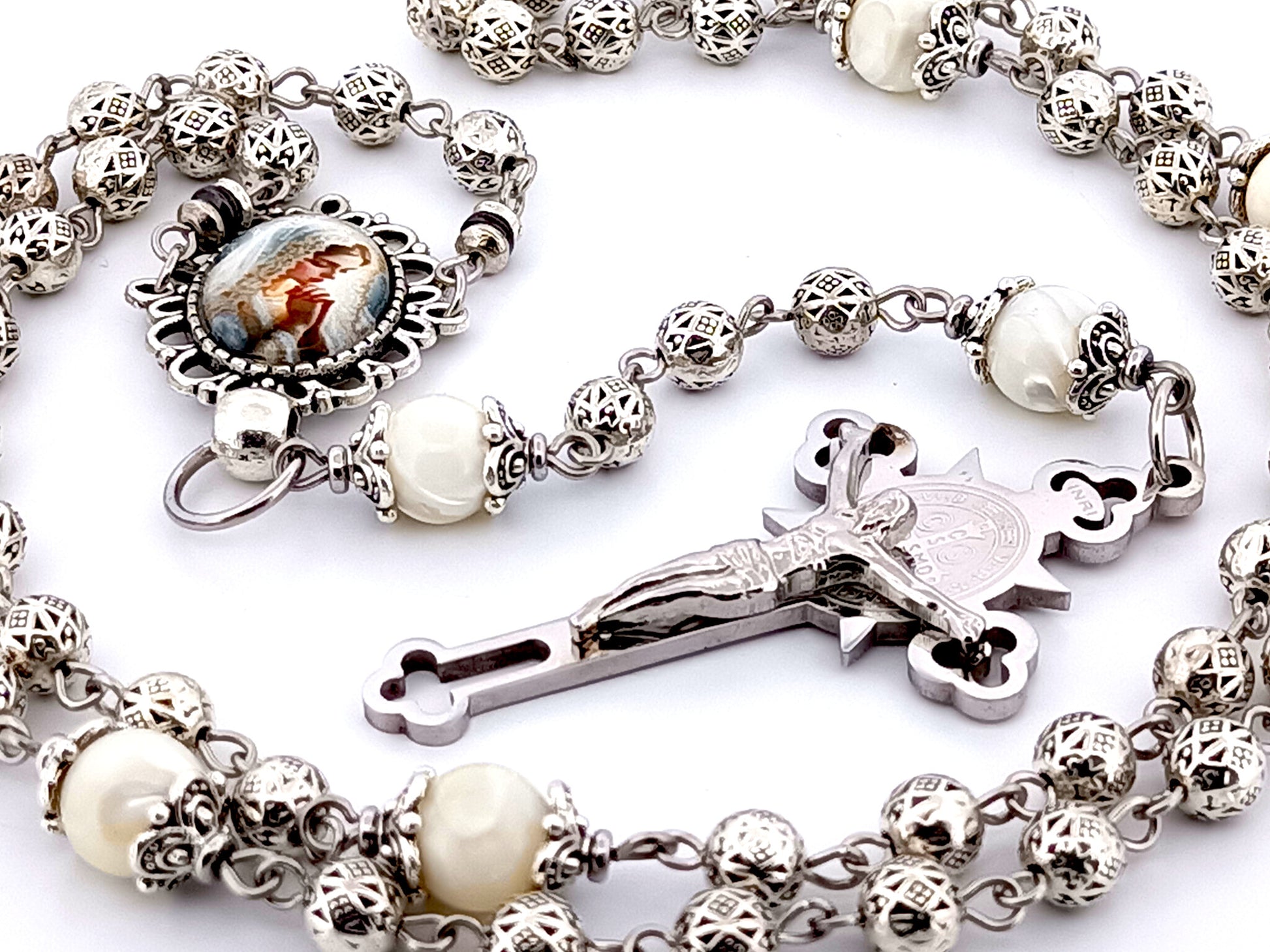 Our Lady Praying silver and mother of pearl unique rosary beads with stainless steel Saint Benedict crucifix.