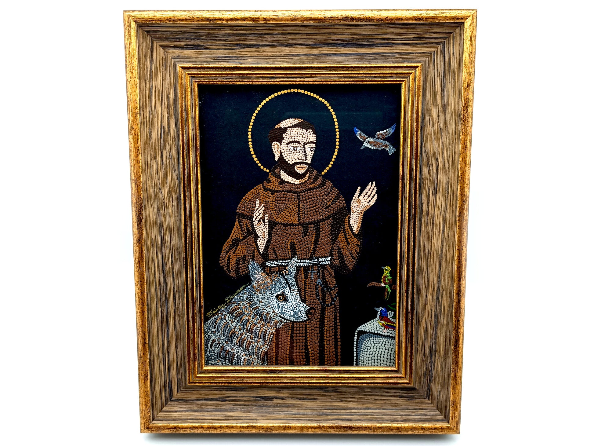 A framed religious icon depicting Saint Francis of Assisi with a brown robe, gold halo, blue-gray wolf, and a dove on a dark background, enclosed in a rustic wooden frame.