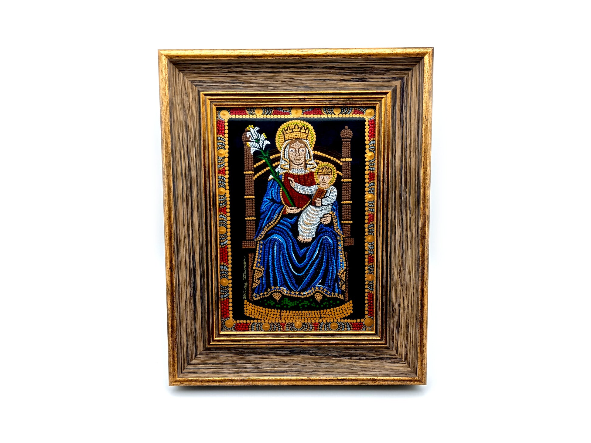 A framed religious artwork depicting the Madonna and Child, with a dark blue robe, gold crown, and ornate multicolor border, set within a wide brown wooden frame on a white background.