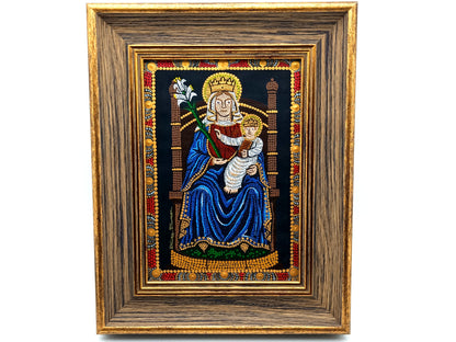A framed religious artwork depicting the Madonna and Child, with a dark blue robe, gold crown, and ornate multicolor border, set within a wide brown wooden frame on a white background.