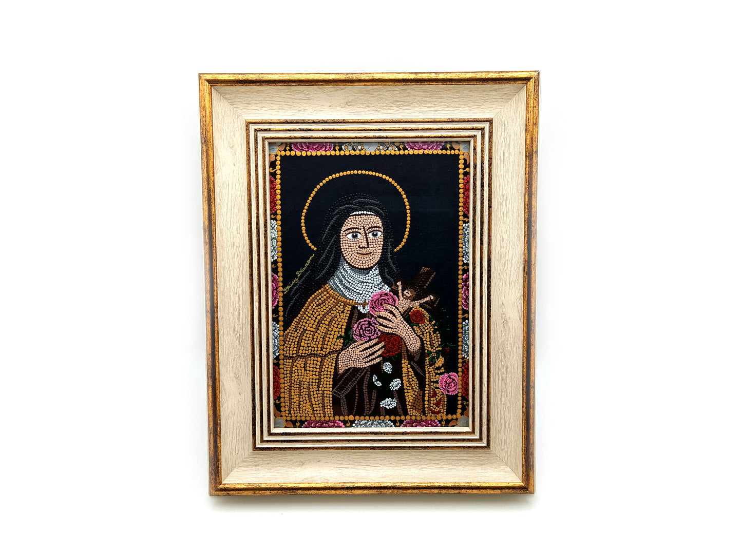 A framed religious mosaic icon portrait of Saint Therese of Lisieux, featuring a cream and gold-toned frame and a detailed multicolor mandala design on a white background.