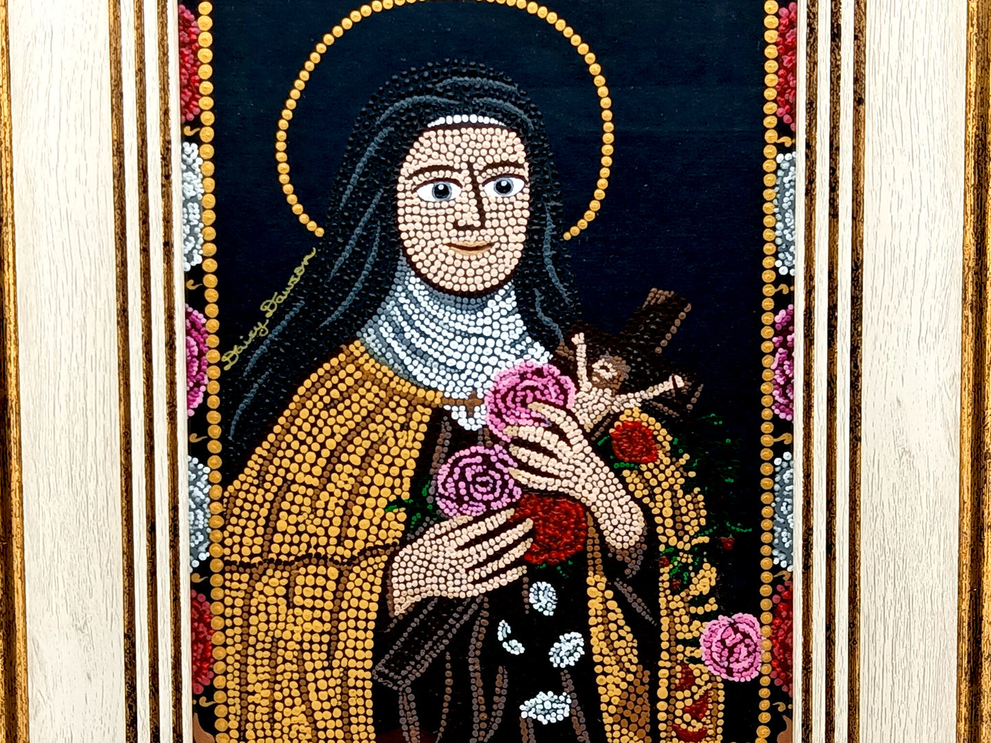 A framed religious mosaic icon portrait of Saint Therese of Lisieux, featuring a cream and gold-toned frame and a detailed multicolor mandala design on a white background.