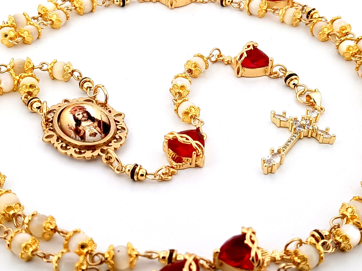 Christ the King mother of pearl and red crystal unique rosary beads with 18K gold plated cubic zirconia cross.