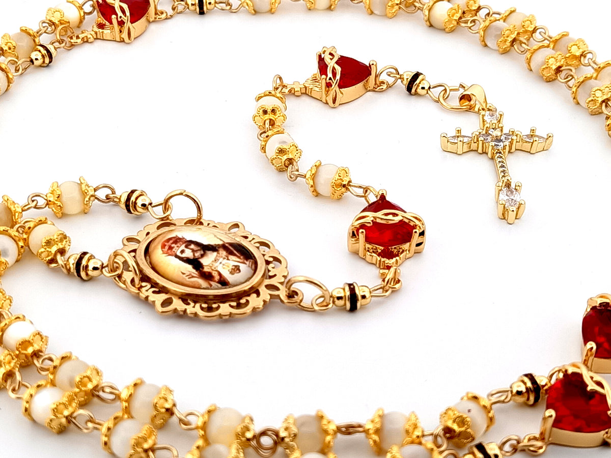 Christ the King mother of pearl and red crystal unique rosary beads with 18K gold plated cubic zirconia cross.