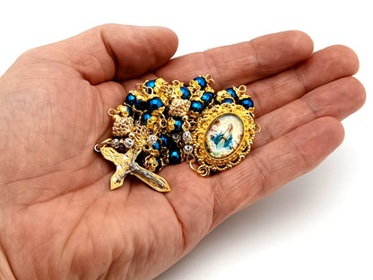 The Assumption of Mary blue hematite gemstone and gold unique rosary beads with layered stainless steel crucifix.