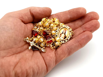 Christ the King mother of pearl and red crystal unique rosary beads with 18K gold plated cubic zirconia cross.