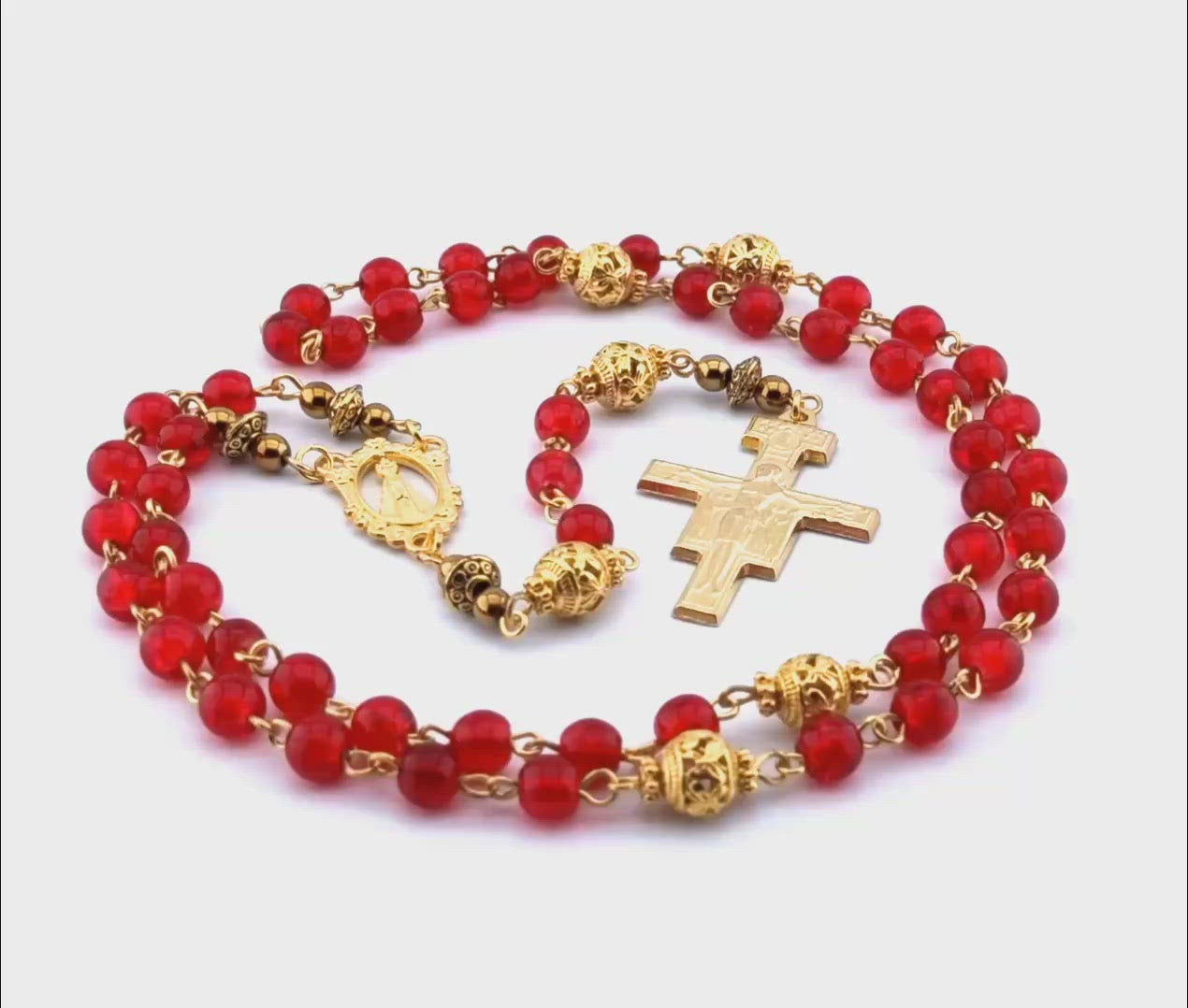 Our Lady of Loretto unique rosary beads with red glass and gold beads, golden Saint Francis crucifix and centre medal.