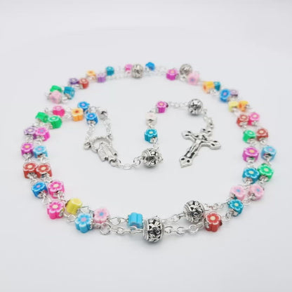 Childrens multicoloured unique rosary beads with poly clay flower beads, silver crucifix, Our Lady medal and pater beads.
