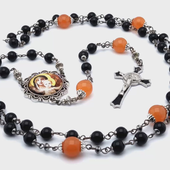Our Lady of Laus unique rosary beads with black onyx gemstone and tangerine glass beads, black enamel crucifix and silver picture centre medal.