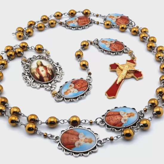 Infant of Prague unique rosary beads with gold hematite gemstone beads, Infant of Prague pater beads, gold and red enamel crucifix and silver picture centre medal.