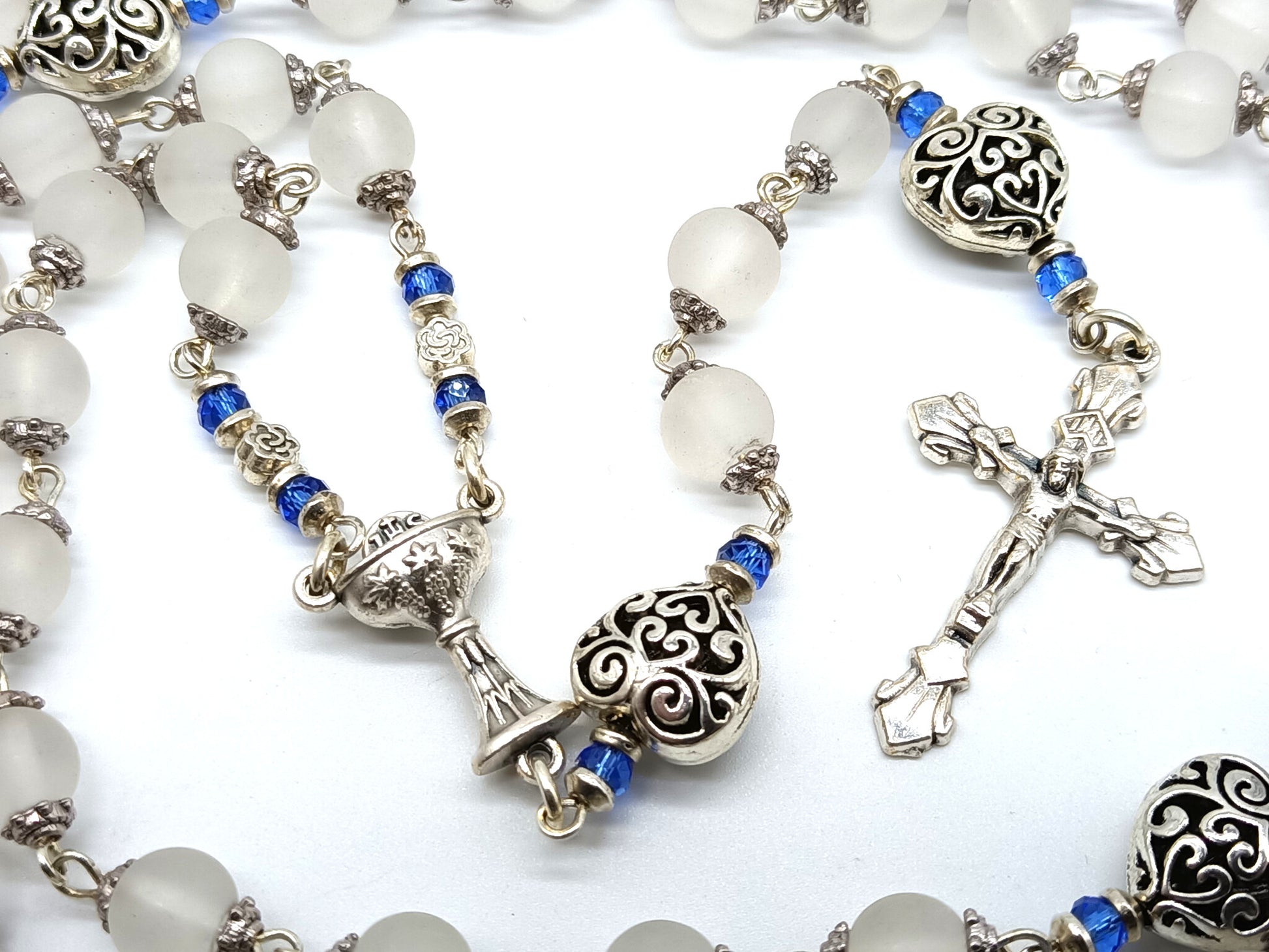 Childs unique rosary beads with white glass beads and silver crucifix and centre medal.