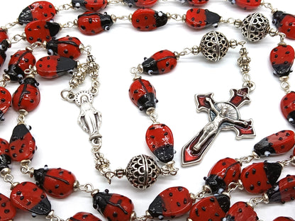 Lady Bug unique rosary beads with glass lady bird beads and red enamel crucifix and silver centre medal.