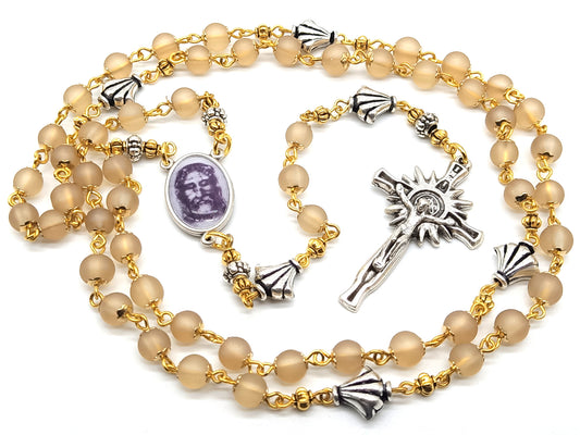 The Holy Face of Jesus rosary beads with pale gold glass beads and silver crucifix and centre medal.