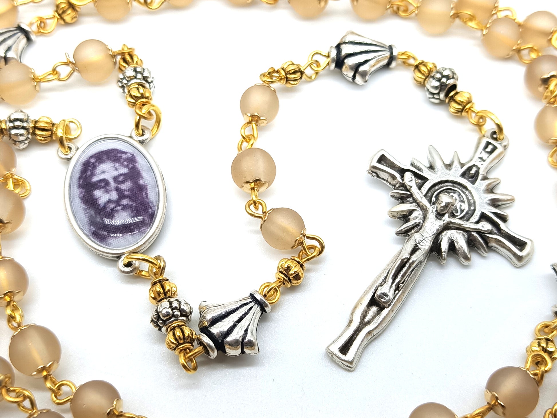 The Holy Face of Jesus rosary beads with pale gold glass beads and silver crucifix and centre medal.