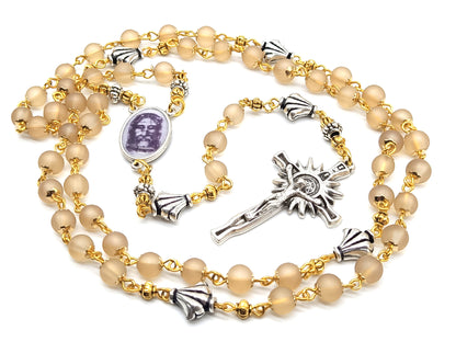 The Holy Face of Jesus rosary beads with pale gold glass beads and silver crucifix and centre medal.