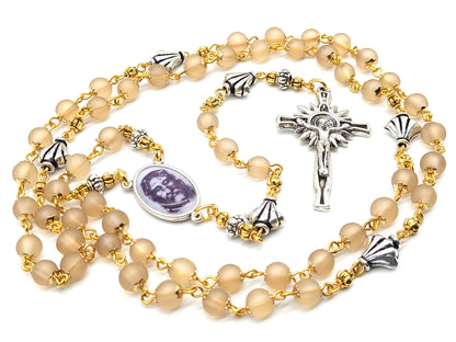 The Holy Face of Jesus rosary beads with pale gold glass beads and silver crucifix and centre medal.