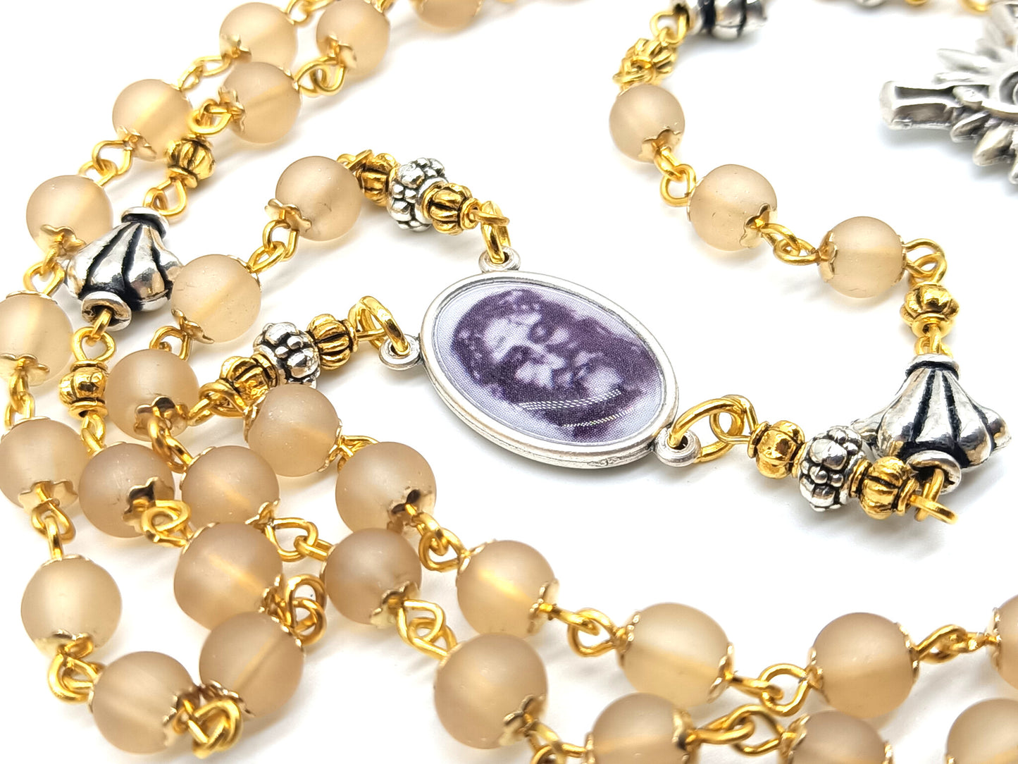 The Holy Face of Jesus rosary beads with pale gold glass beads and silver crucifix and centre medal.