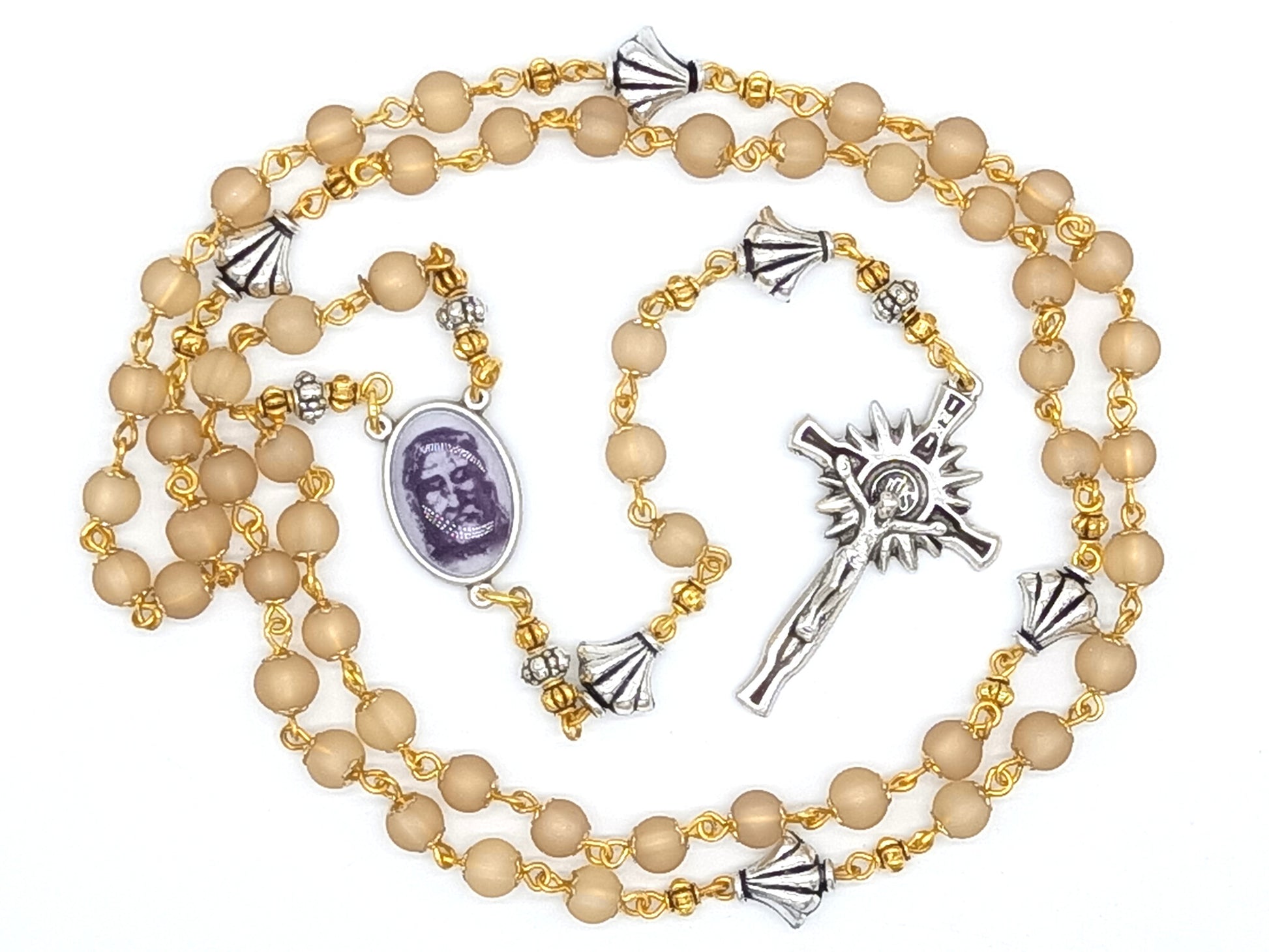 The Holy Face of Jesus rosary beads with pale gold glass beads and silver crucifix and centre medal.