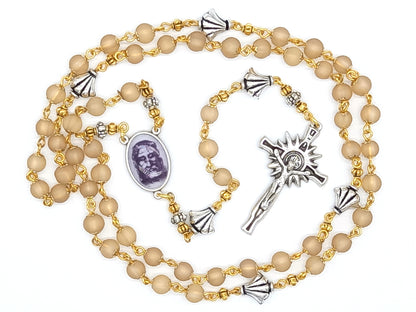 The Holy Face of Jesus rosary beads with pale gold glass beads and silver crucifix and centre medal.