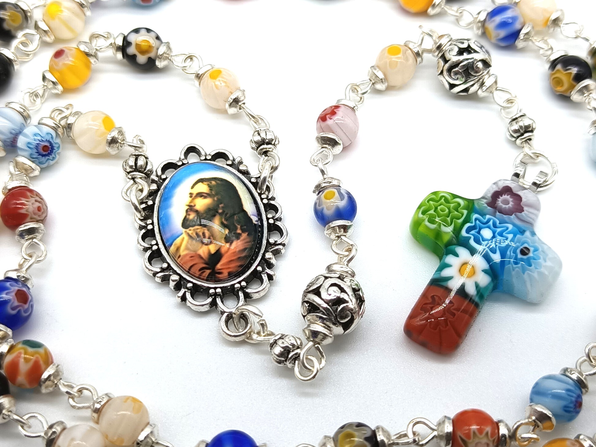 Millefiori glass unique rosary beads with Jesus face centre medal, silver pater beads and millefiori crucifix.