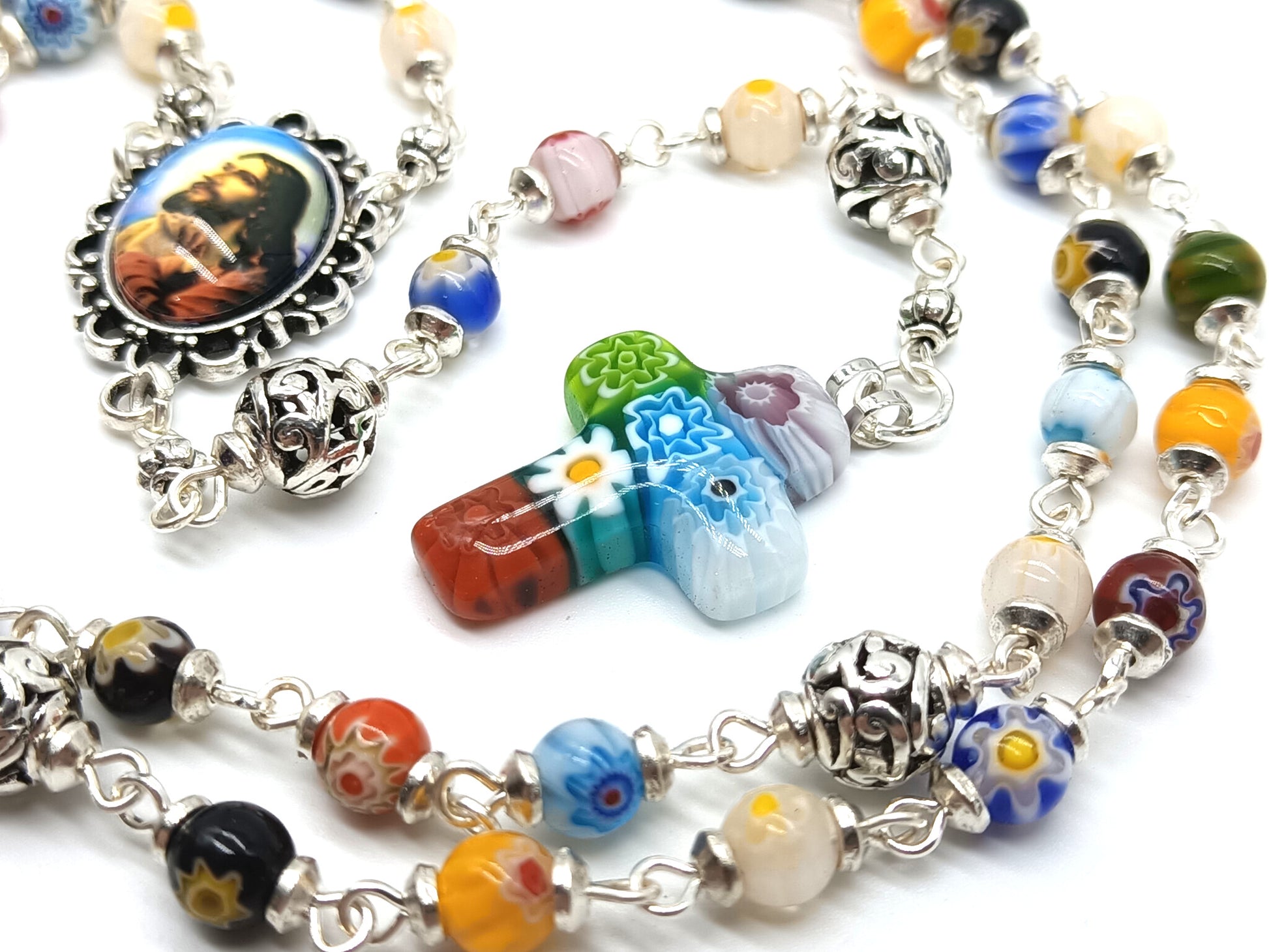 Millefiori glass unique rosary beads with Jesus face centre medal, silver pater beads and millefiori crucifix.