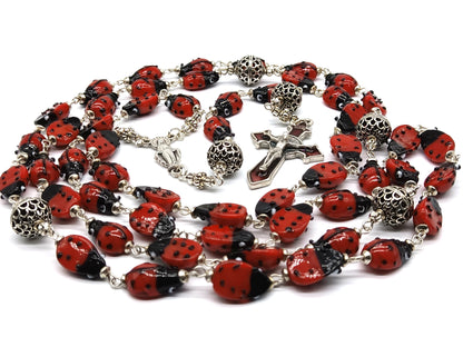 Lady Bug unique rosary beads with glass lady bird beads and red enamel crucifix and silver centre medal.