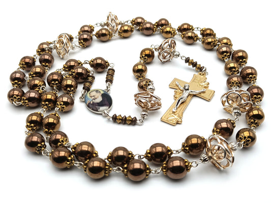 Saint Padre Pio unique rosary beads with copper hematite beads, gold lily crucifix, silvered copper pater beads and picture centre medal.