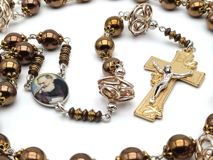 Saint Padre Pio unique rosary beads with copper hematite beads, gold lily crucifix, silvered copper pater beads and picture centre medal.