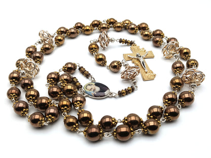 Saint Padre Pio unique rosary beads with copper hematite beads, gold lily crucifix, silvered copper pater beads and picture centre medal.