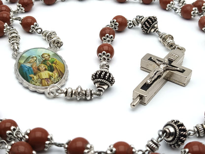 Holy Family unique rosary beads with brown gemstone beads, reliquary crucifix, silver pater beads, and picture centre medal. 